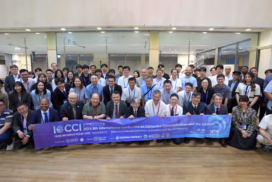 ICCCI 2026 attendees pose for a group photo while holding the conference banner