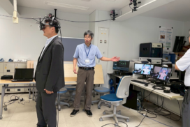 A visitor tries a virtual reality headset during a motion-tracking laboratory demonstration